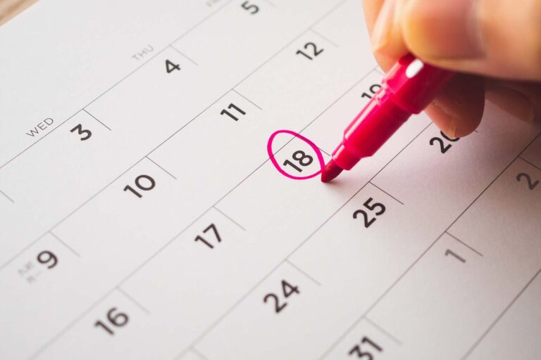 woman circling a date in a calendar