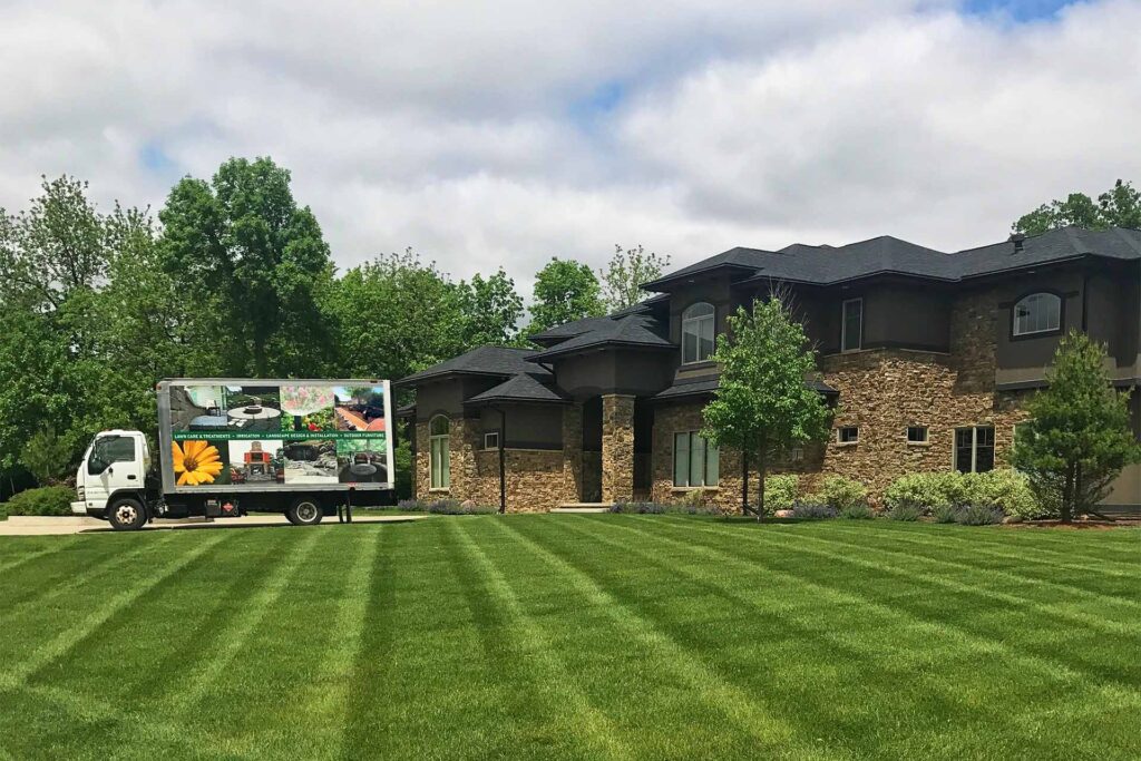 beautiful lawn in a home with truck in the driveway